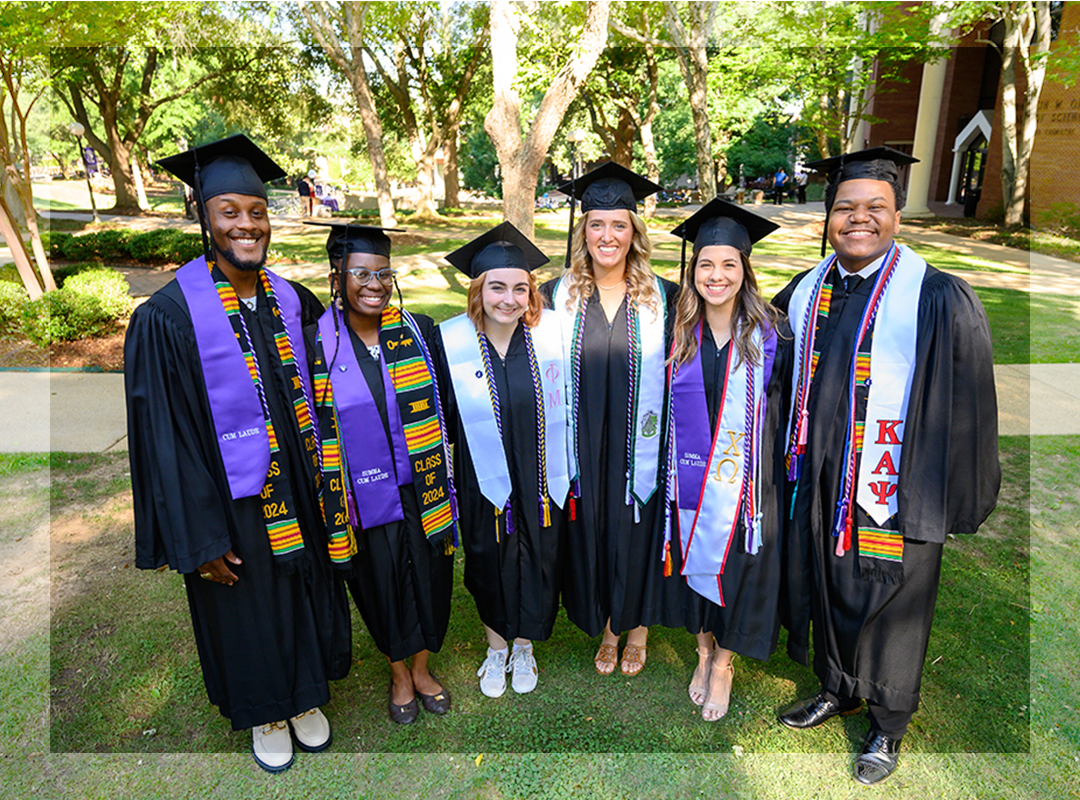 Six students posing for a photo at graduation